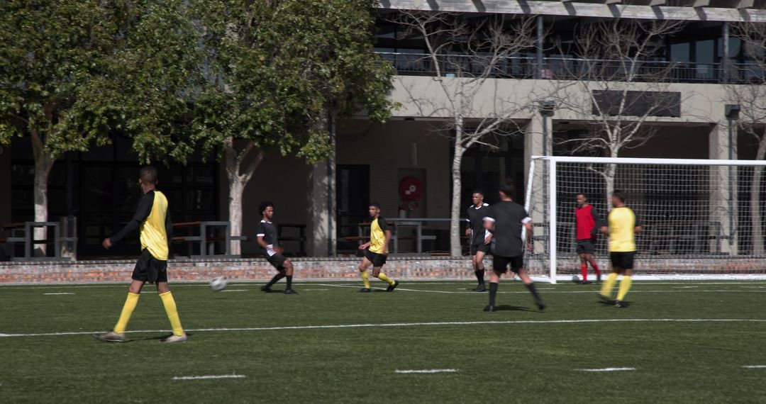Soccer Players on Field Engaged in Team Strategy Under Sun
