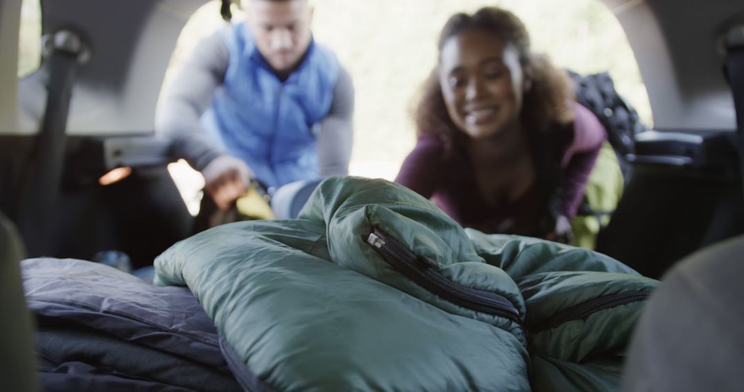 Couple Preparing for Outdoor Camping Trip by Loading Sleeping Bags in Car - Free Images, Stock Photos and Pictures on Pikwizard.com