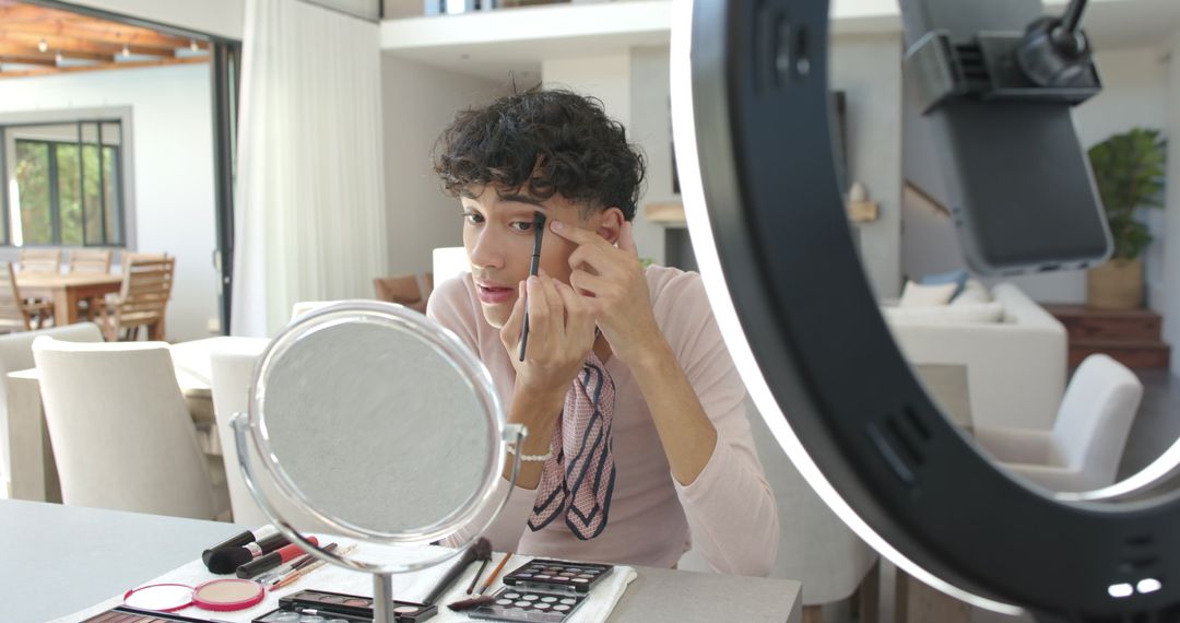 Man Applying Makeup at Home with Ring Light and Smartphone