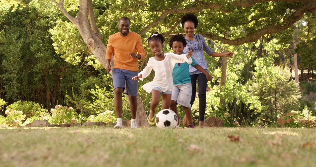 Happy African American Family Playing Soccer Outdoors Together - Free Images, Stock Photos and Pictures on Pikwizard.com