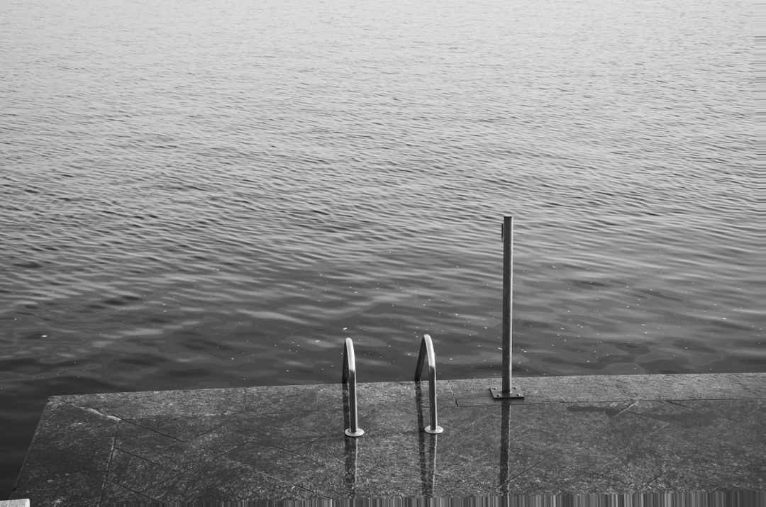 Minimalist Black and White Ocean View from Stone Dock - Free Images, Stock Photos and Pictures on Pikwizard.com