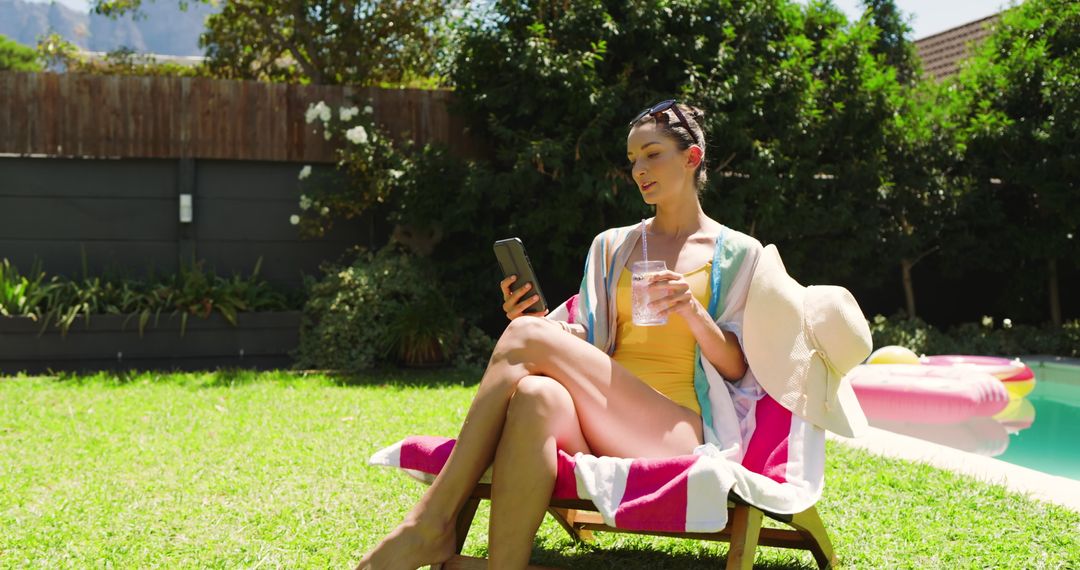 Woman Relaxing by Pool with Smartphone and Drink on Sunny Day