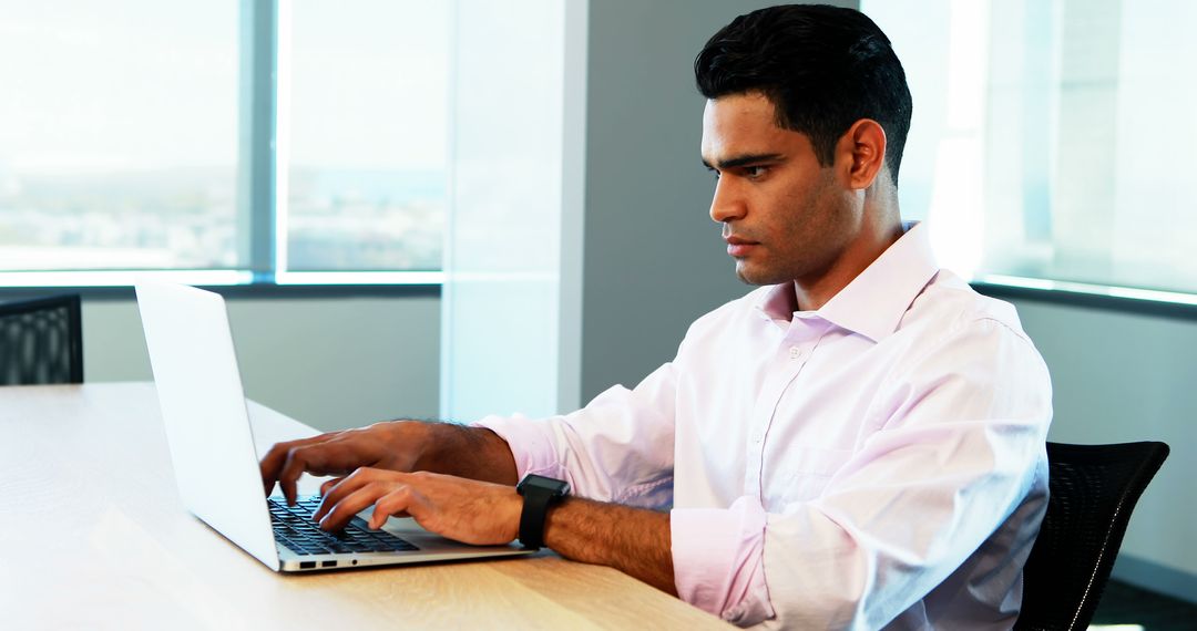 Focused Businessman Working on Laptop at Office Desk - Free Images, Stock Photos and Pictures on Pikwizard.com