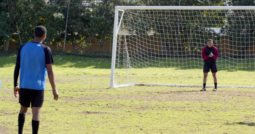 Players Practicing Penalty Kick on Soccer Field in Park