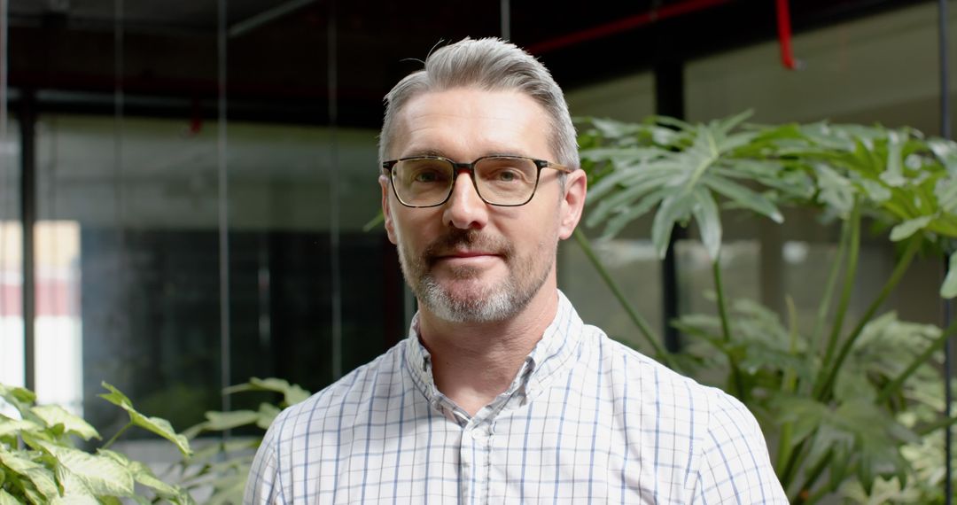 Confident Businessman Smiling in Modern Office Plot