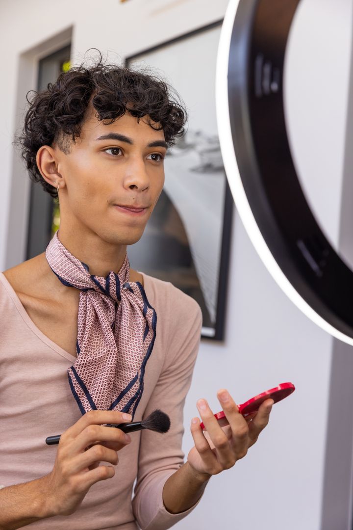 Inclusive Beauty Blogger Applying Makeup in Studio Lighting