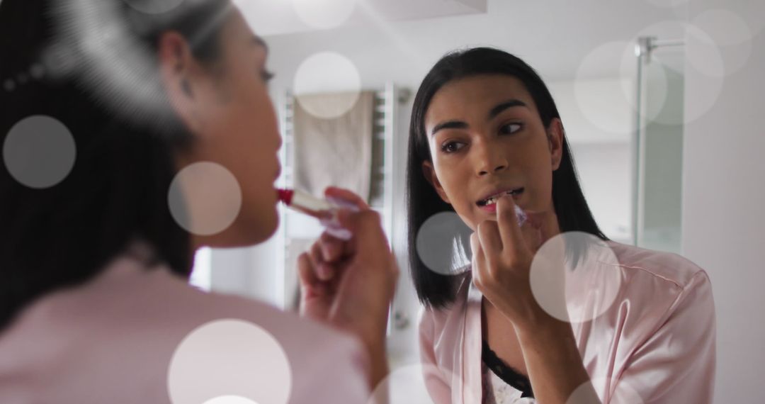 Woman Applying Lipstick in Soft Lighting Ambiance