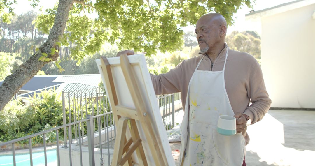 Senior Man Painting Outdoors on a Sunny Day - Free Images, Stock Photos and Pictures on Pikwizard.com