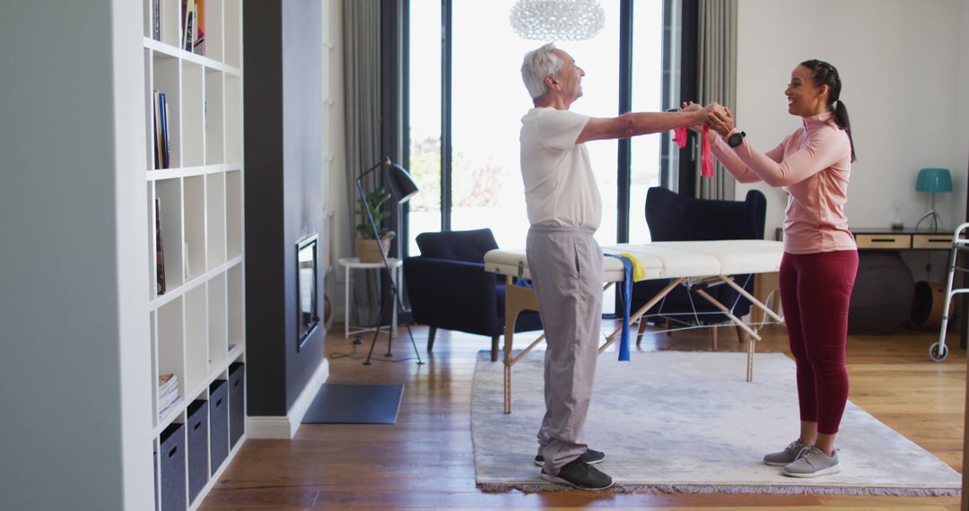 Senior Man Exercising with Therapist in Modern Living Room - Free Images, Stock Photos and Pictures on Pikwizard.com