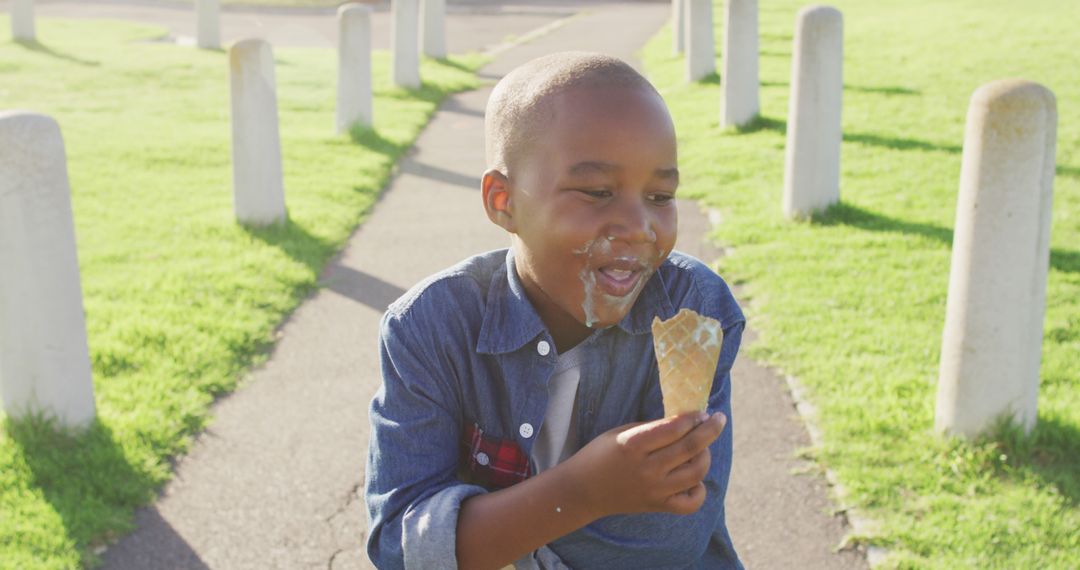 Image of happy african american boy eating ice creams on sunny day - Free Images, Stock Photos and Pictures on Pikwizard.com