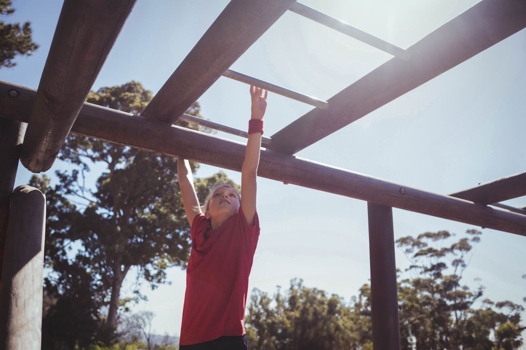 Child Reaching on Playground Monkey Bars