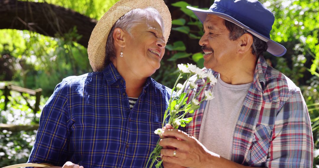 Senior Latino Couple Enjoying Outdoor Nature With Flowers - Free Images, Stock Photos and Pictures on Pikwizard.com