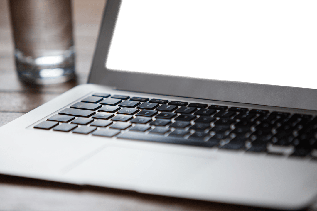 Transparent Laptop with Glass of Water on Wooden Surface