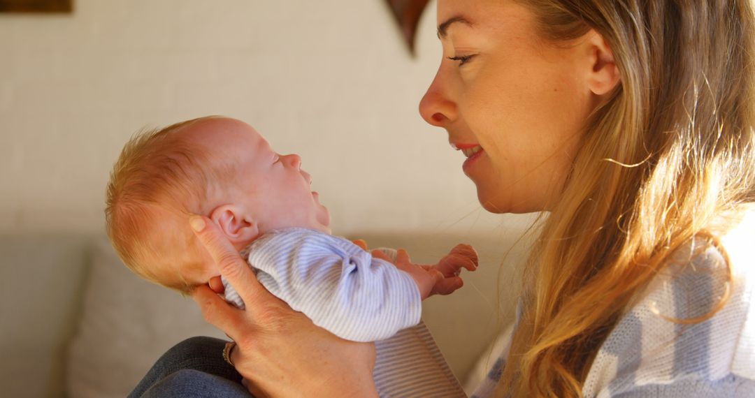 Newborn Baby Holding by Smiling Mother in Natural Light - Free Images, Stock Photos and Pictures on Pikwizard.com