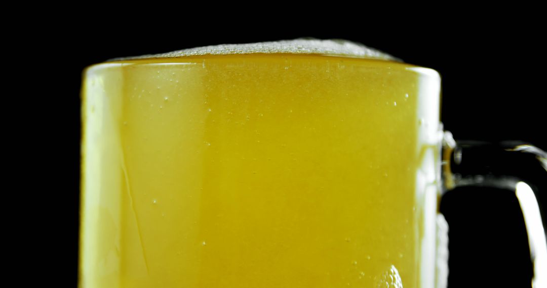 Close-Up of Foaming Beer in a Glass Mug on Black Background - Free Images, Stock Photos and Pictures on Pikwizard.com