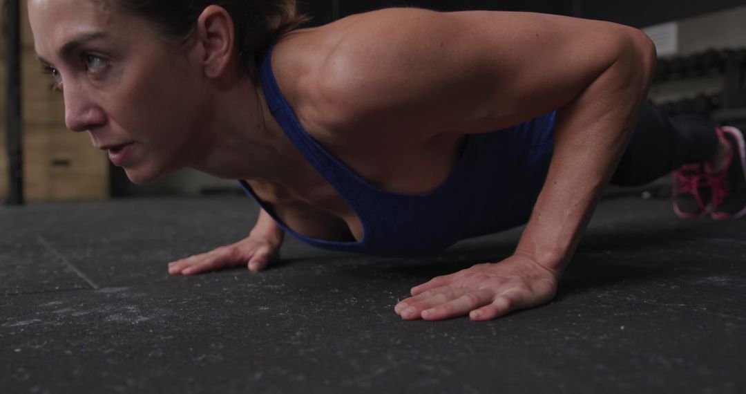 Athletic Woman Performing Push-Ups in Gym Close-Up