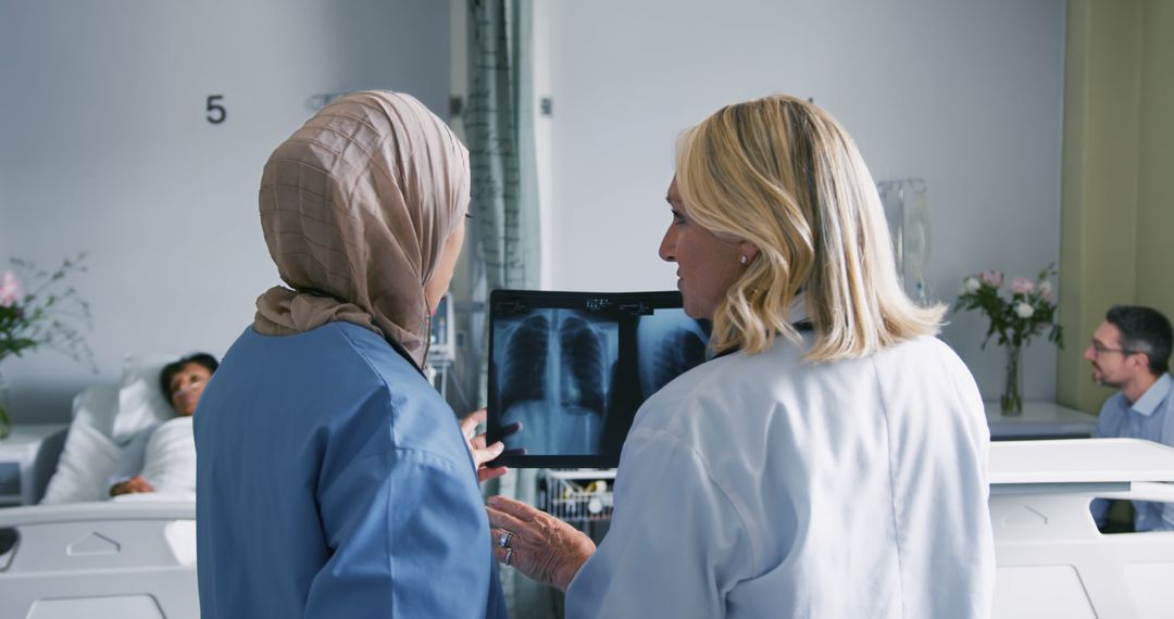 Medical Professionals Discussing Patient's X-Ray in Hospital Room - Free Images, Stock Photos and Pictures on Pikwizard.com