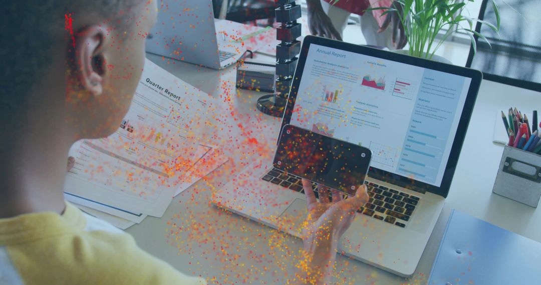 Colleague Analyzing Annual Report on Laptop in Office Environment