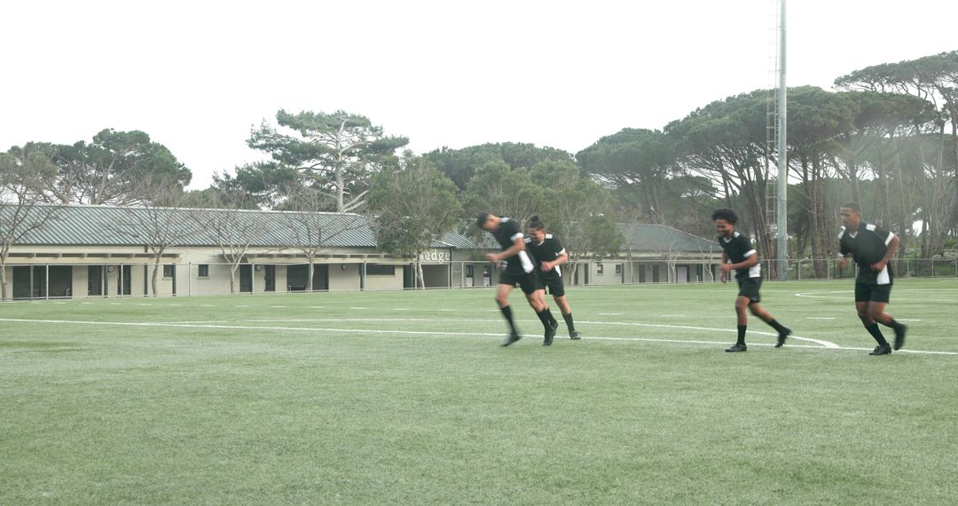 Soccer Players Practicing Agility and Teamwork Outdoors