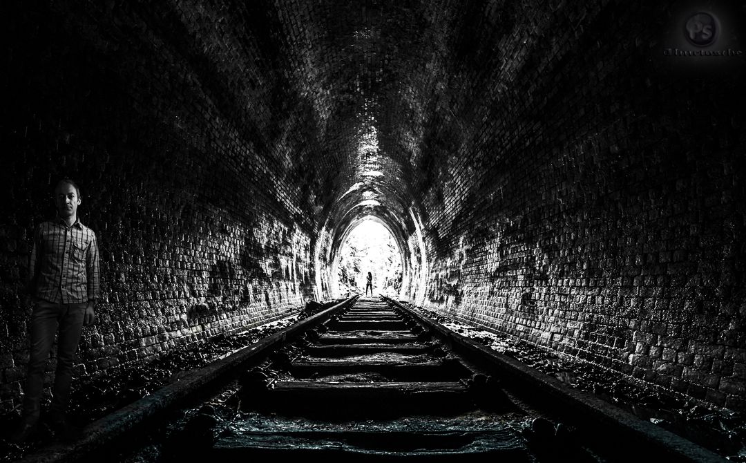 Man Standing in Dark Tunnel with Light at the End - Free Images, Stock Photos and Pictures on Pikwizard.com