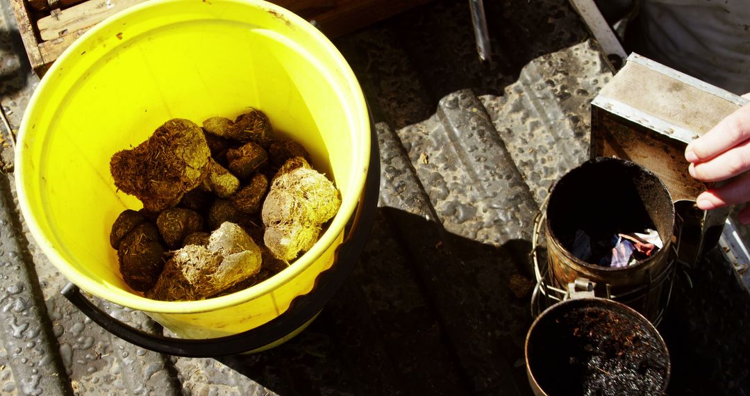 Close-up of Yellow Bucket with Collected Rocks in Outdoor Work Area - Free Images, Stock Photos and Pictures on Pikwizard.com