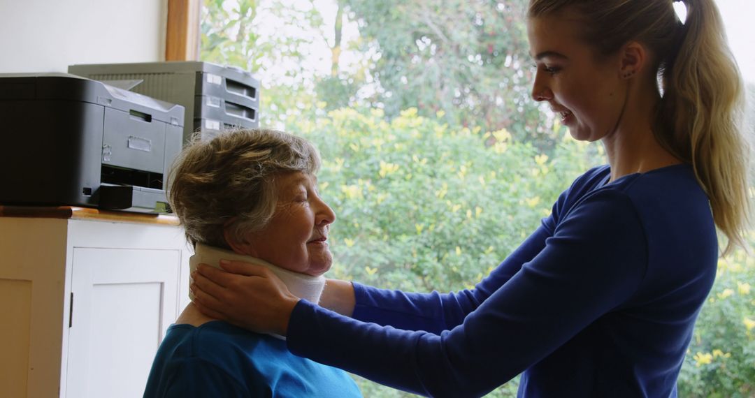 Healthcare Worker Adjusting Brace on Senior Woman's Neck - Free Images, Stock Photos and Pictures on Pikwizard.com