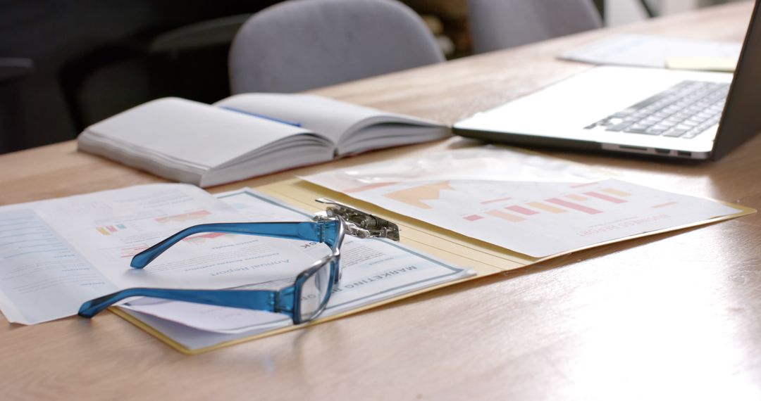 Business Presentation Documents and Laptop on Office Desk