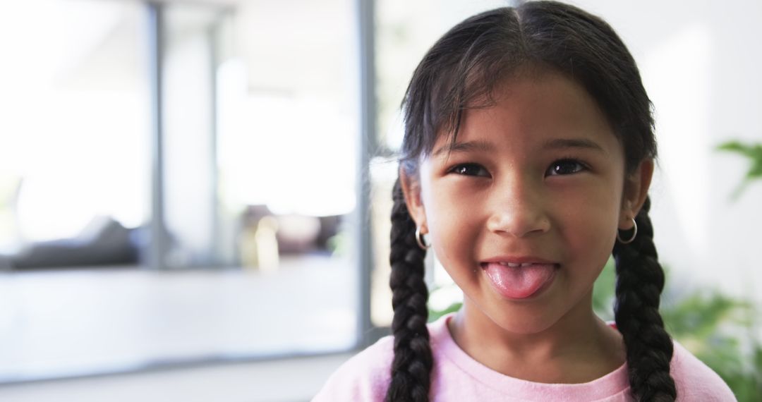 Joyful Biracial Girl Showing Playful Expression Indoors