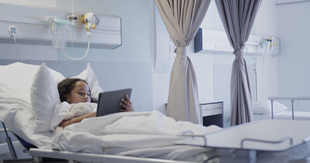 Sick Child Lying in Hospital Bed Using Digital Tablet - Free Images, Stock Photos and Pictures on Pikwizard.com