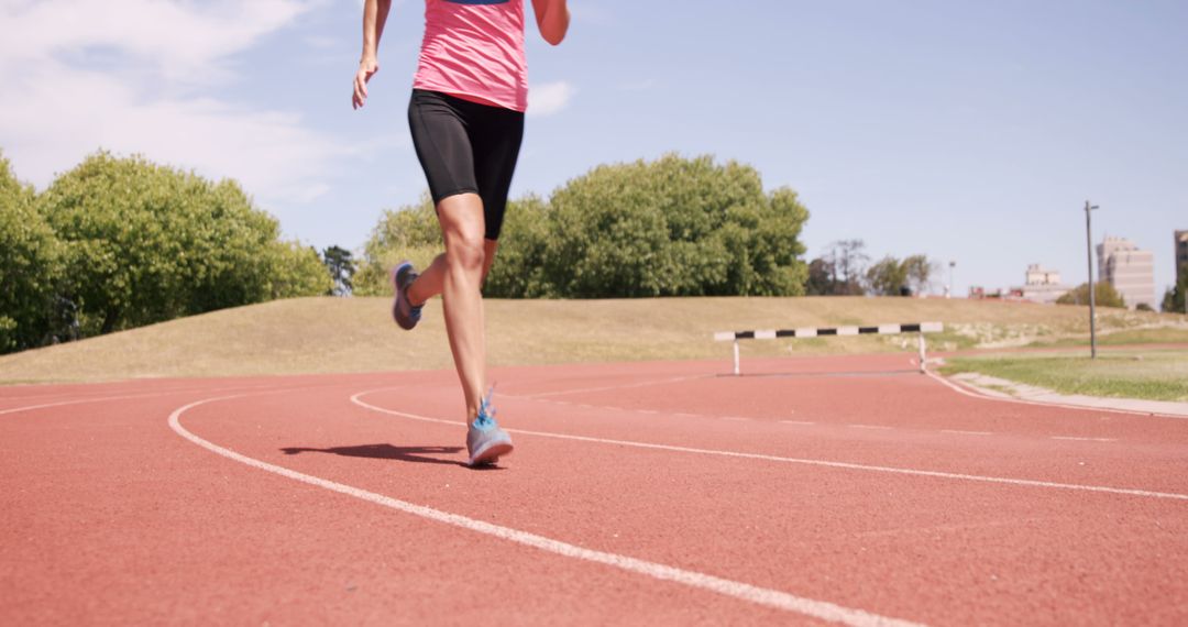 Woman Jogging on Outdoor Track in Bright Morning Light - Free Images, Stock Photos and Pictures on Pikwizard.com