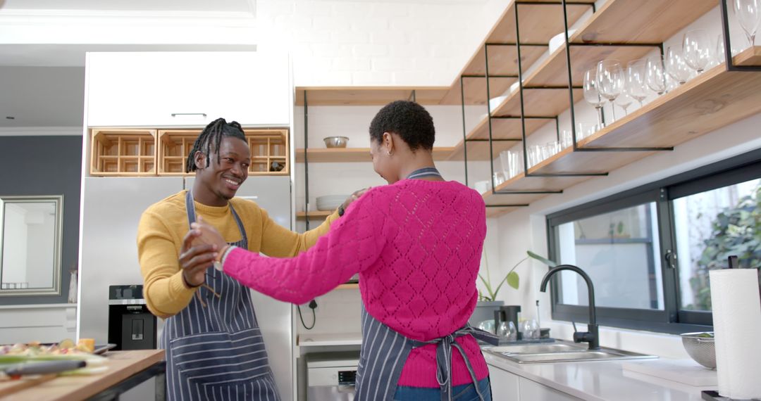 Couple Joyfully Dancing in Modern Home Kitchen
