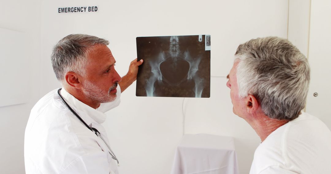 Doctor Explaining Pelvic X-Ray to Patient in Emergency Room - Free Images, Stock Photos and Pictures on Pikwizard.com