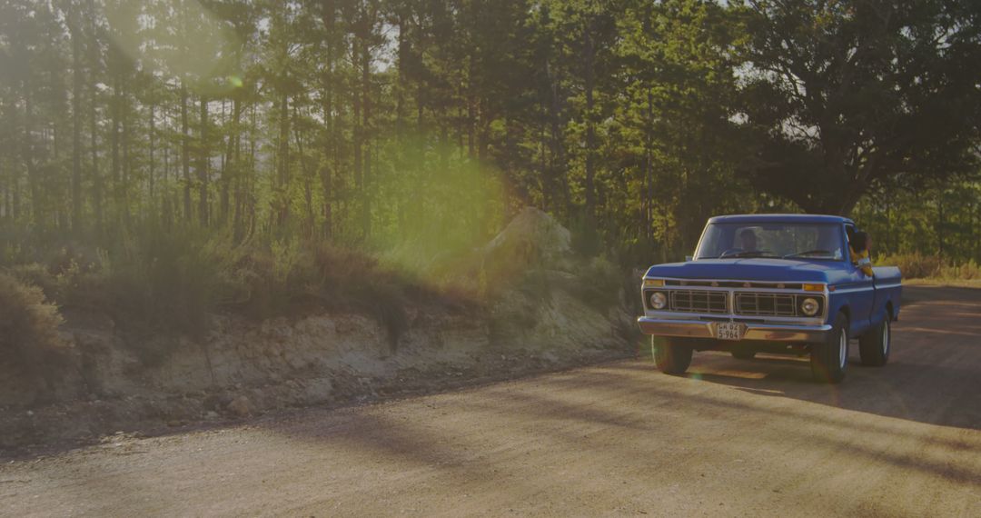 Vintage blue truck driving on a dusty road, with copy space - Free Images, Stock Photos and Pictures on Pikwizard.com