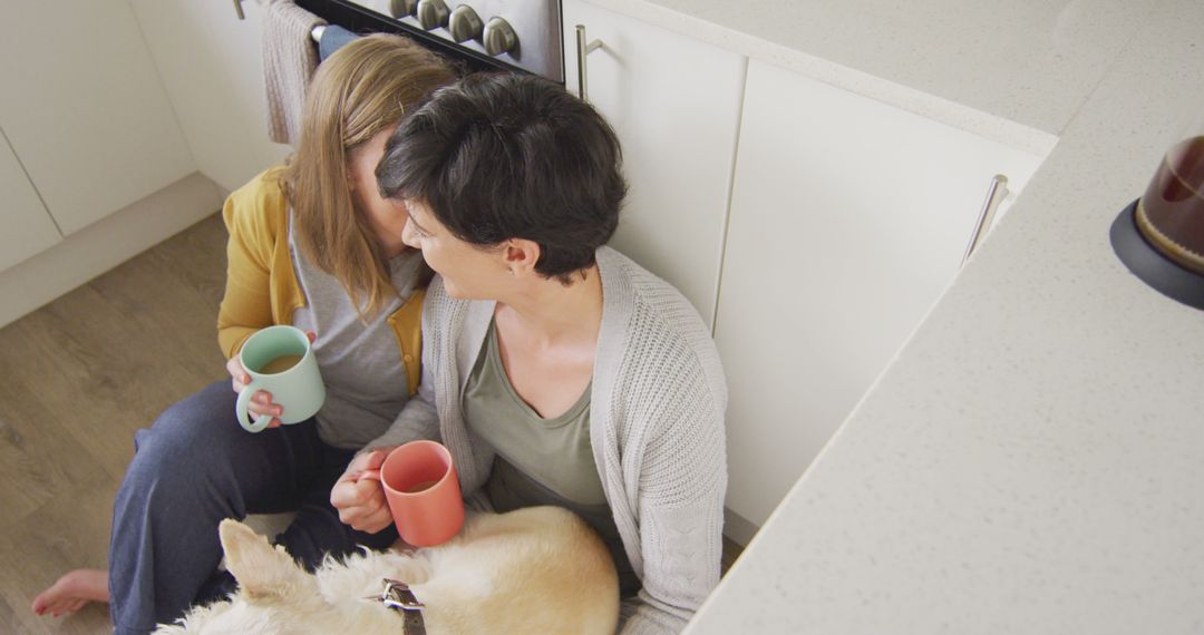 Caucasian lesbian couple embracing each other while having coffee together in the kitchen at home - Free Images, Stock Photos and Pictures on Pikwizard.com