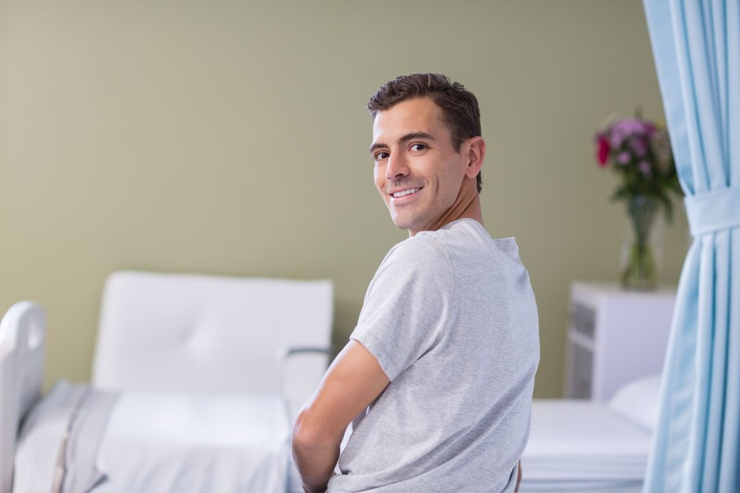 Man Smiling in Hospital Room Indicating Recovery and Wellbeing