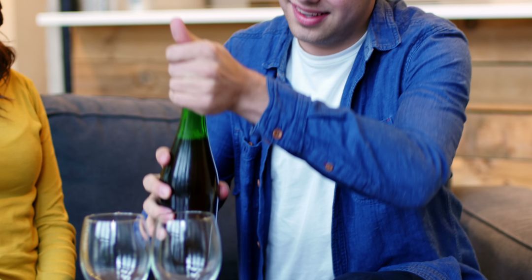 Happy Man Opening Wine Bottle with Friends at Home - Free Images, Stock Photos and Pictures on Pikwizard.com