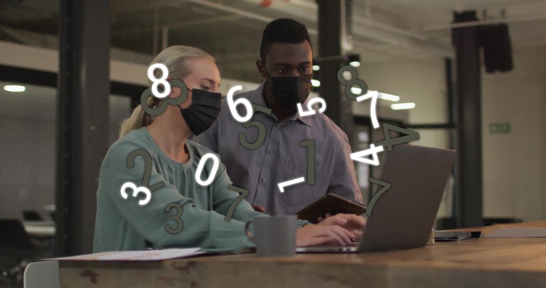 Colleagues Wearing Masks Analyzing Data in Modern Office Environment