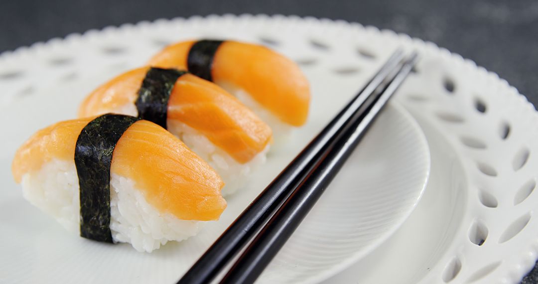 Salmon Nigiri Sushi on White Lace Plate with Chopsticks - Free Images, Stock Photos and Pictures on Pikwizard.com