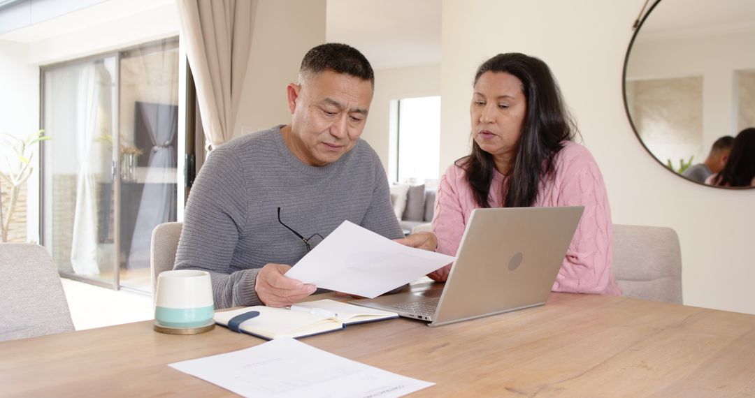 Father and Daughter Reviewing Documents Together at Home