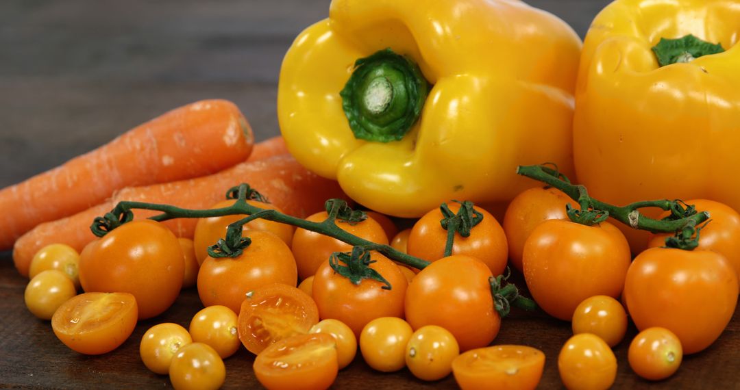 Close-up of Fresh Yellow Bell Peppers, Tomatoes, and Carrots on Wooden Surface - Free Images, Stock Photos and Pictures on Pikwizard.com