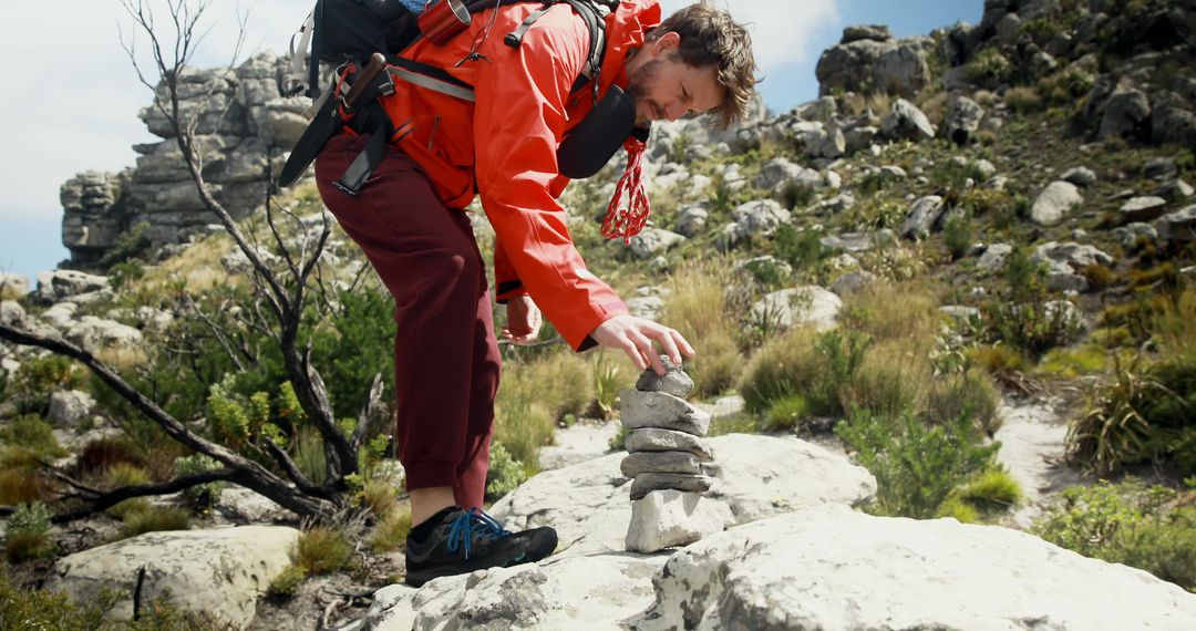 Male Hiker Balancing Rocks on Rugged Trail in Mountainous Landscape - Free Images, Stock Photos and Pictures on Pikwizard.com