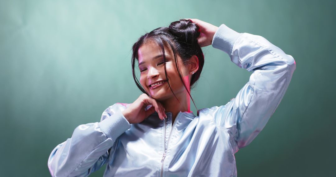 Smiling Woman Posing Confidently in Trendy Metallic Bomber Jacket
