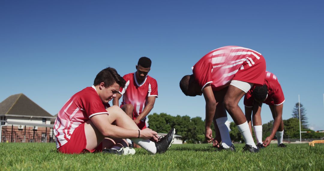 Soccer Players Tying Laces Outdoors Before Practice - Free Images, Stock Photos and Pictures on Pikwizard.com