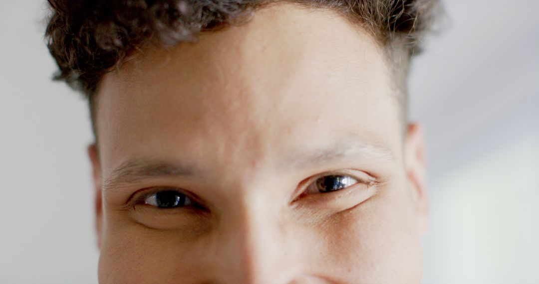 Close-up of Smiling Man with Curly Hair and Bright Eyes - Free Images, Stock Photos and Pictures on Pikwizard.com