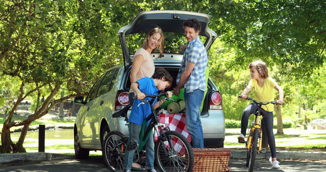 Family unloading camping gear from car in forest park - Free Images, Stock Photos and Pictures on Pikwizard.com