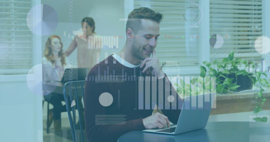 Man Analyzing Data on Laptop in Modern Office