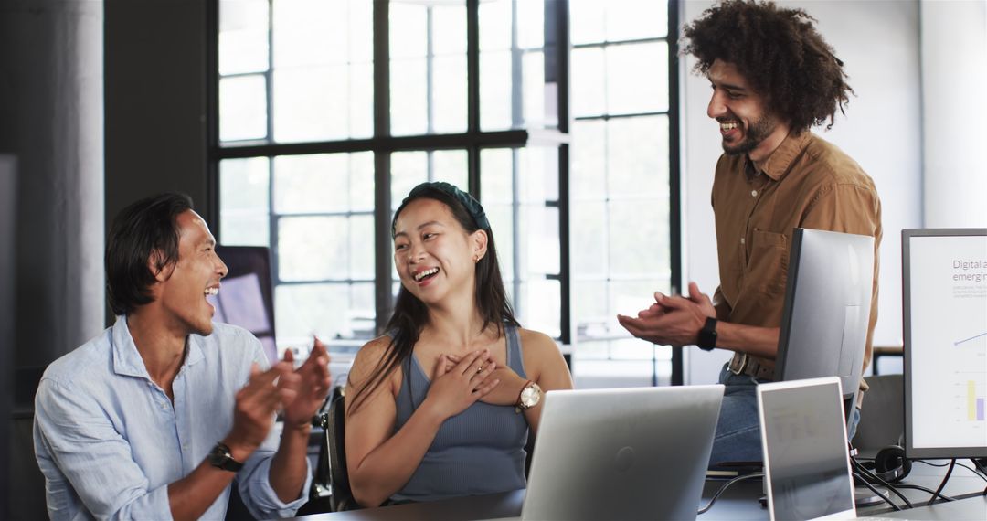 Diverse Team Celebrating Success in Modern Office Setting