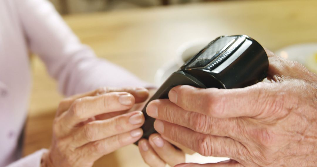 Senior Customer Using Contactless Payment Terminal for Transaction - Free Images, Stock Photos and Pictures on Pikwizard.com