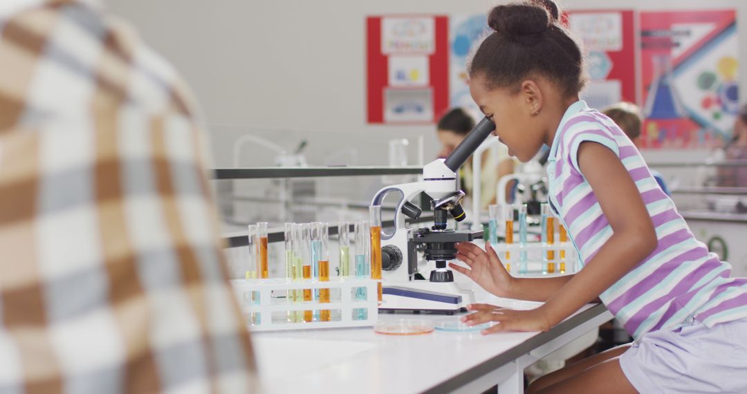 Image of happy african american girl with microscope during lesson - Free Images, Stock Photos and Pictures on Pikwizard.com