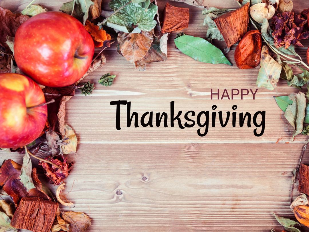 Thanksgiving Greeting with Apples and Autumn Leaves on Rustic Wood